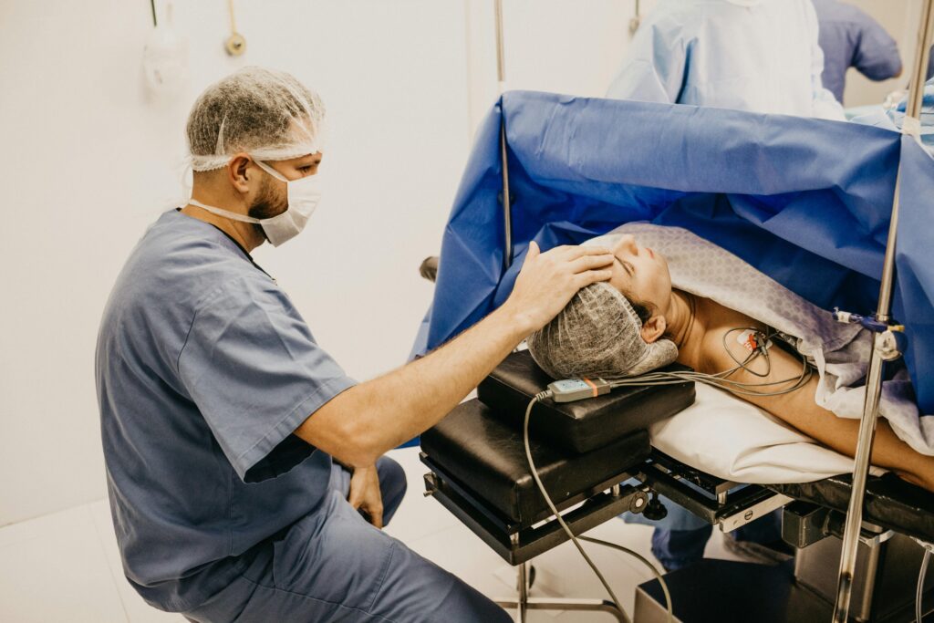pexels-photo-3279196-3279196 Surgeon offering comfort to a patient about to undergo surgery in a hospital operating room.